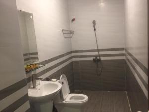 a bathroom with a toilet and a sink at Binh Minh Hotel in Vung Tau