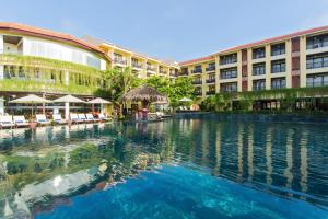 a swimming pool in front of a hotel at Bel Marina Hoi An Resort in Hoi An