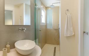 a bathroom with a sink and a glass shower at Yellow house in Parga