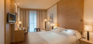 Posteľ alebo postele v izbe v ubytovaní SH Valencia Palace