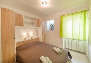 Postel nebo postele na pokoji v ubytování Apartmani Sandra Rovini