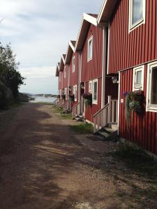 a row of red houses on the side of a road at Seaview Cottage Solvik - Kungshamn in Kungshamn