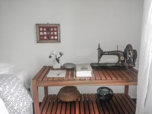 an old sewing machine sitting on a table next to a bed at ilab rural bed&breakfast in Navia