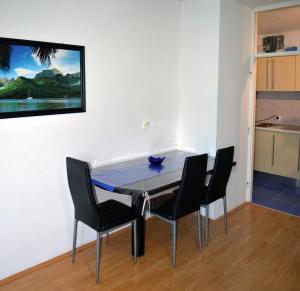 a dining room with a table and four chairs at Meri Apartment in Rijeka +7 photos
