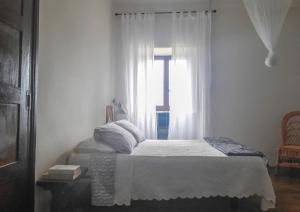 a bedroom with a bed and a window at ilab rural bed&breakfast in Navia