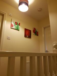 a room with paintings on the wall and a staircase at Livingston 4 bedroom townhouse in Livingston +22 photos