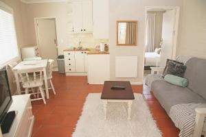 a living room with a couch and a table at The Winelands Guest House in Bellville