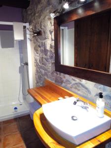 a bathroom with a sink and a mirror at La caseta de Pedris in Valderrobres