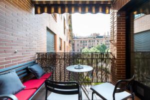 a patio with a table and chairs on a balcony at Premium luxury city center apartment in Madrid