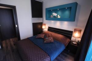 a bedroom with a bed with two pillows and two lamps at Stella Baltic 2 in Świnoujście