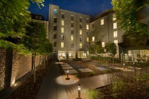 an exterior view of a building at night at Hotel Conti Duisburg - Partner of SORAT Hotels in Duisburg