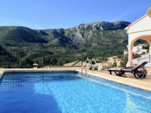 a swimming pool with a view of a mountain at Belvilla by OYO Les Bassetes in Adsubia