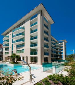 an apartment building with a swimming pool at Artis Appartamento in Rimini