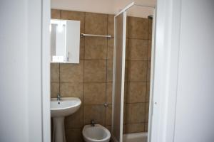 a bathroom with a sink and a toilet and a mirror at La Residenza City in Rome