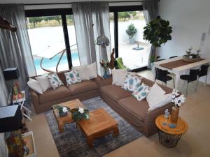 a living room with a couch and a table at Belvilla by OYO Casa del Ananas in San Pedro del Pinatar