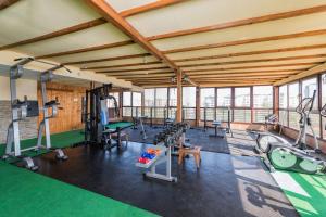 a gym with treadmills and exercise equipment in a building at Avenue Hotel in Burgas City