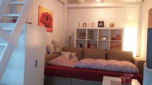 a living room with a couch with a teddy bear on it at Ferienwohnung Ideenreich in Bad Neuenahr-Ahrweiler