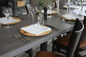 a table with plates and wine glasses on it at Trasti & Trine Boutique Hotel in Alta