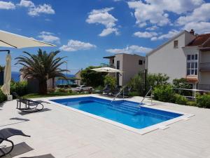 ein Swimmingpool im Hinterhof eines Hauses in der Unterkunft Apartments Diamond in Podstrana