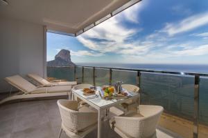a dining room with a view of the ocean at ESTIMAR Calpe Suitopia in Calpe