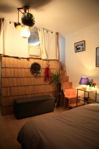 a bedroom with a bed and a window and stairs at Cabane l'hiver in Arcachon