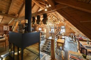 a large room with wooden ceilings and a dining room at Hotel Station in Pontresina