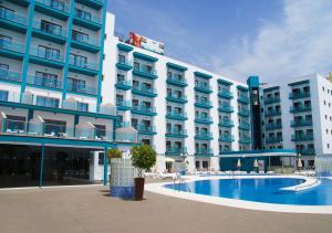 a hotel with a swimming pool in front of a building at Hotel Ritual Torremolinos- Adults Only in Torremolinos