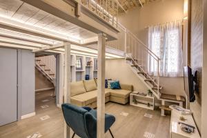 a living room with a couch and a staircase at Domus Urbana in Rome