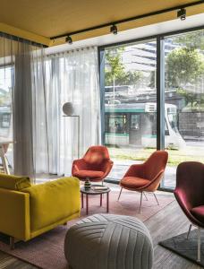 a living room filled with furniture and a window at Okko Hotels Paris Porte De Versailles in Paris