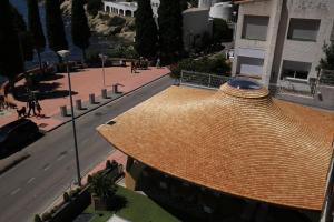 an overhead view of a straw roof on a street at Canyelles Platja in Roses