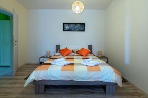 a bedroom with a large bed with orange pillows at Apartment Valmas in Pula