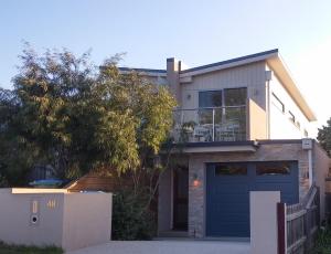 a large house with a blue garage at Shellys Place in Rosebud