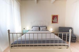 a small bedroom with a bed and a chair at B&B In Acquaviva in Livorno