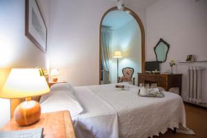 a hotel room with a bed and a mirror at Hotel Victoria Maiorino in Cava deʼ Tirreni