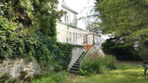 a house with a staircase leading up to it at Hotel D'Angleterre in Roscoff