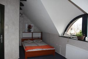 a bedroom with a bed with a window at Privat pri Hradbach in Levoča