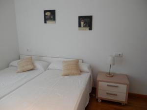 Łóżko lub łóżka w pokoju w obiekcie Apartamento Dicar