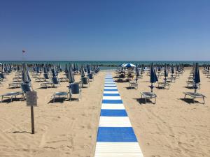 a long line of chairs and umbrellas on a beach at Casa Meri in Montesilvano