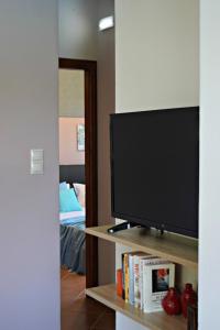 a television sitting on a shelf in a room at Aspalathos Villas in Fílippos