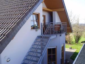 a house with a staircase and a window at Ferienwohnung Haus Giesner in Kappel