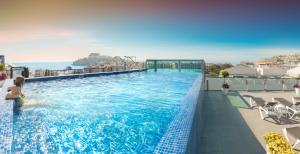 a swimming pool on the roof of a building at RH Don Carlos & Spa in Peñíscola