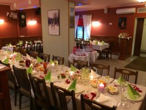 a dining room with white tables with green bows at Veski Guesthouse in Antsla