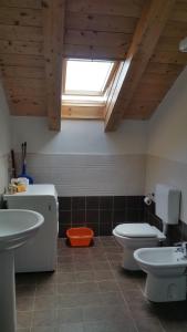 a bathroom with a sink and a toilet and a window at LES BIJOUX Apartments in Pietra Ligure