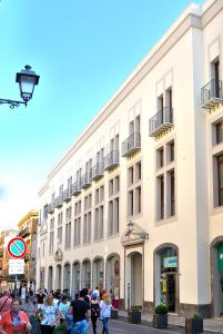 a group of people standing in front of a building at Alla Corte Maqueda in Palermo