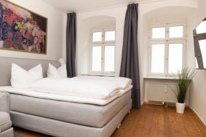 Ein Bett oder Betten in einem Zimmer der Unterkunft KulturQuartier