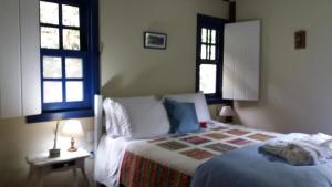 Cama ou camas em um quarto em Pousada Ribeirao da Floresta