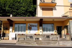 a building with a sign on the side of it at Hotel Poggio d'Oro in Riva di Solto