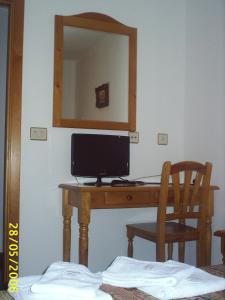 a desk with a computer on it with a mirror at Gabarre in Broto