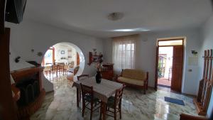 a living room with a table and a dining room at Villa La Favola in Ischia