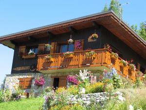 une maison avec un balcon fleuri dans l'établissement Chalet la Ravine, à Valmorel
